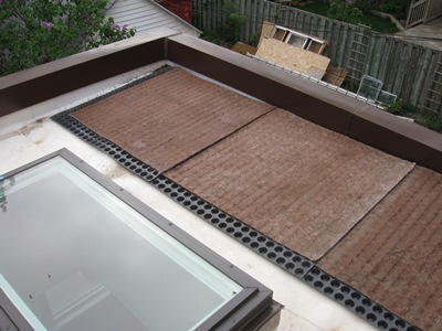 Green roof substrate: a plastic sheet with water-holding cups, and a layer of felt.